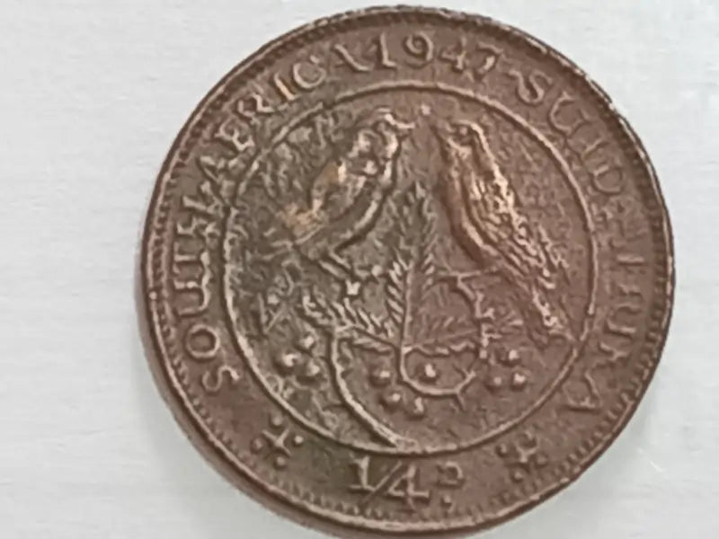 Old 1947 REVERSE coin with intricate design on a white background
