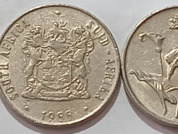 50 cent coin from South Africa, Obverse: Coat of arms + mintage date
on a light gray background.