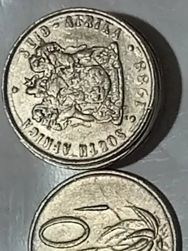 Two 1988 10 CENT COINS on a metallic surface