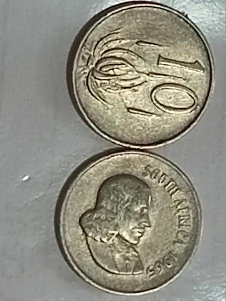 Two 1965 10 Cent coins on grey surface