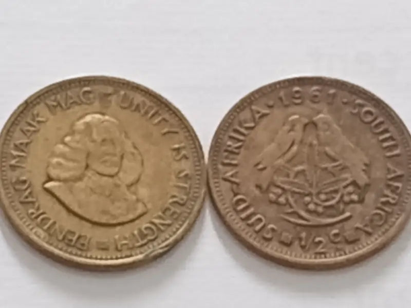 Two 1961 coins from South Africa on a white background