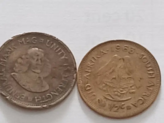 Two vintage coins from South Africa on a white background