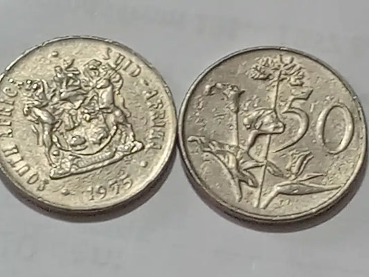 Two 1975 50c coins with different designs on a gray background