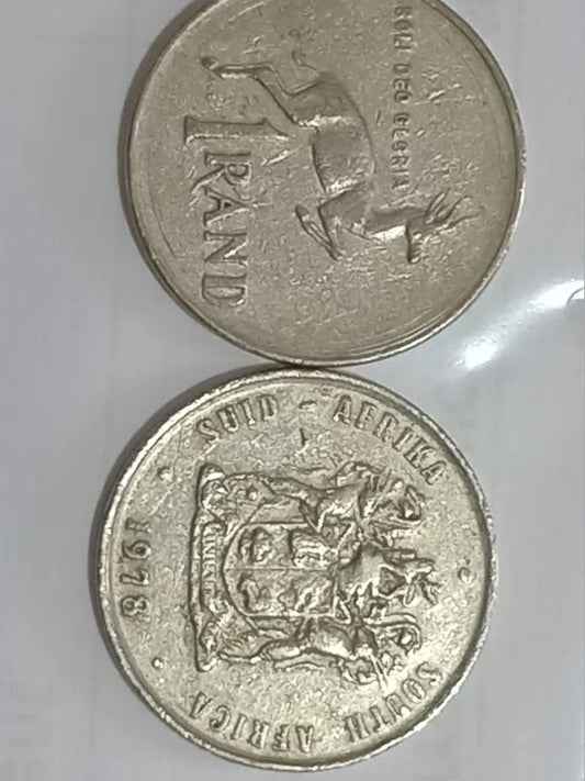 Two 1984  R1 coins from South Africa on a white background