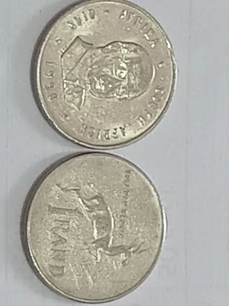 Two one rand/ R1  coins with springbok embossed designs on a gray background