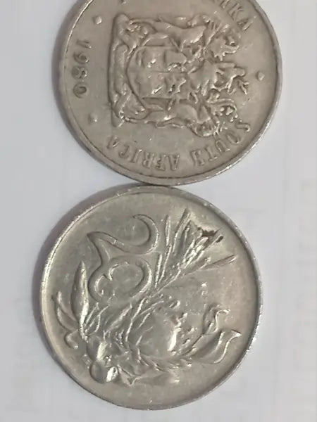 Two 1980 20 cent coins on a white background