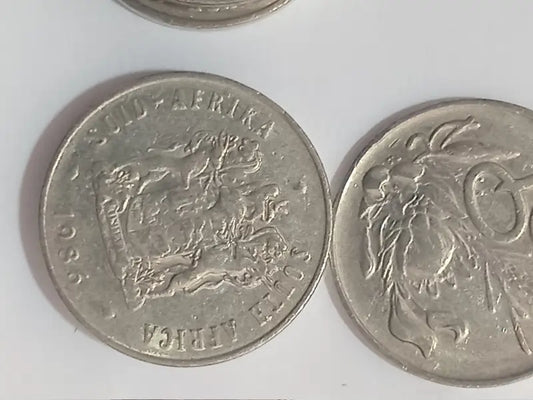 Two 1987 20c coins from South Africa on a white background