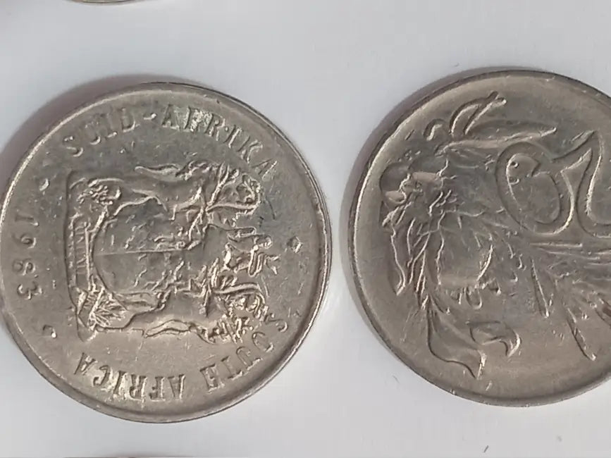 Two 1983 20 cent coins on grey background