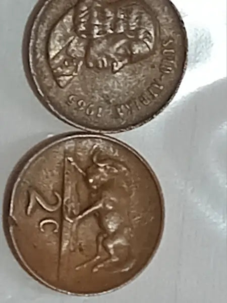 Two 1965 - 2 Cent Presidential series antique coins on a white background