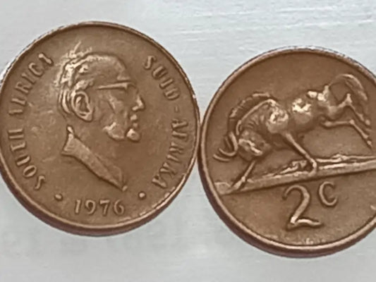 Two 1976 - 2 Cent presidential series bronze coins on a silver background