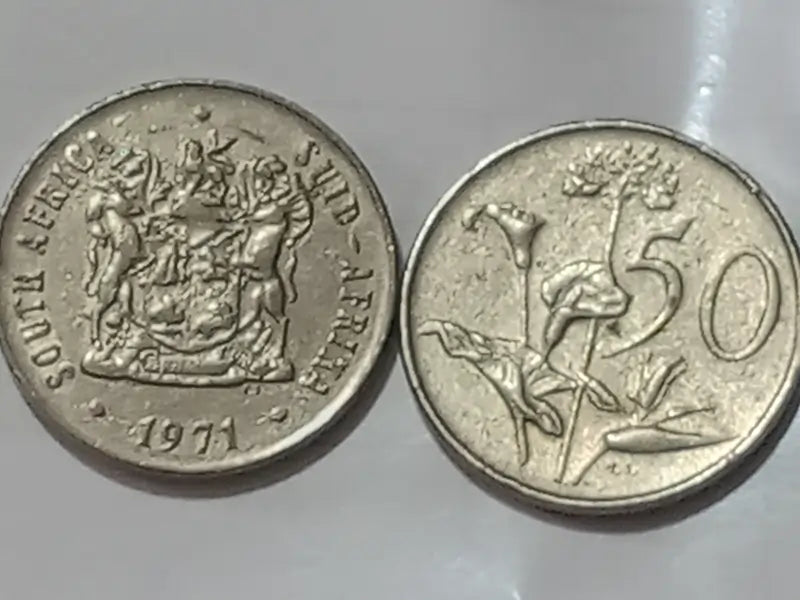 Two 50 cent coins,Obverse: Coat of arms of South Africa.
Reverse: Protea flower on a reflective surface.