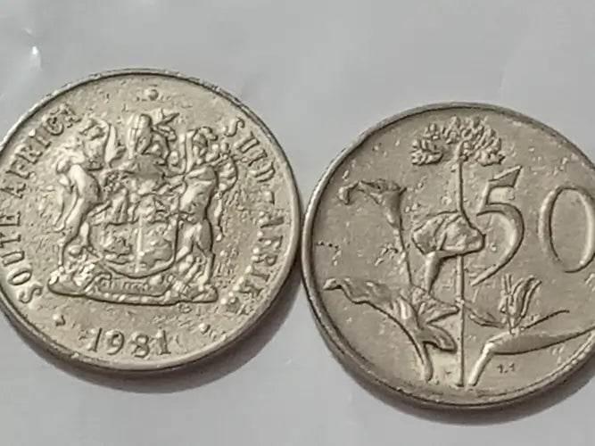 Two  50 cent coins obverse displaying coat of arms ,mintage '1981. Reverse displaying the protea  and '50' denominations on a grey background.