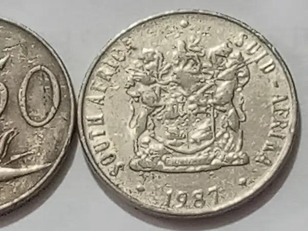 Obverse: Coat of arms of South Africa/dual language
 'Sud Africa' and mintage year  '1987', on a light gray background.