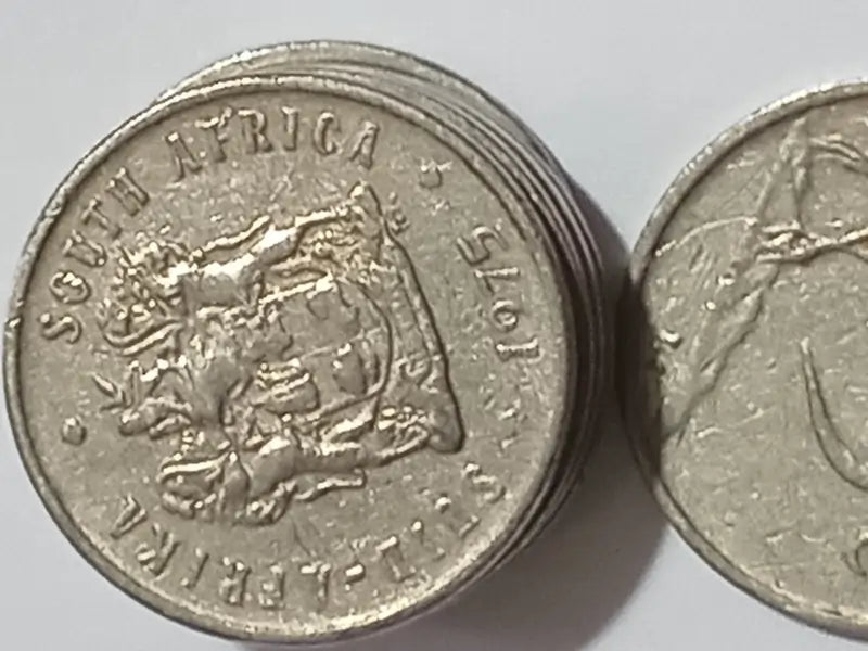 Two 1975 - 5 Cent coins on a light gray background