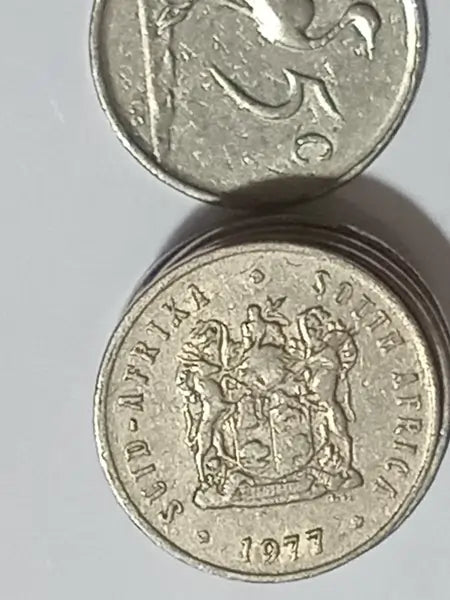Two 1977 - 5 Cent coins on a light gray background.