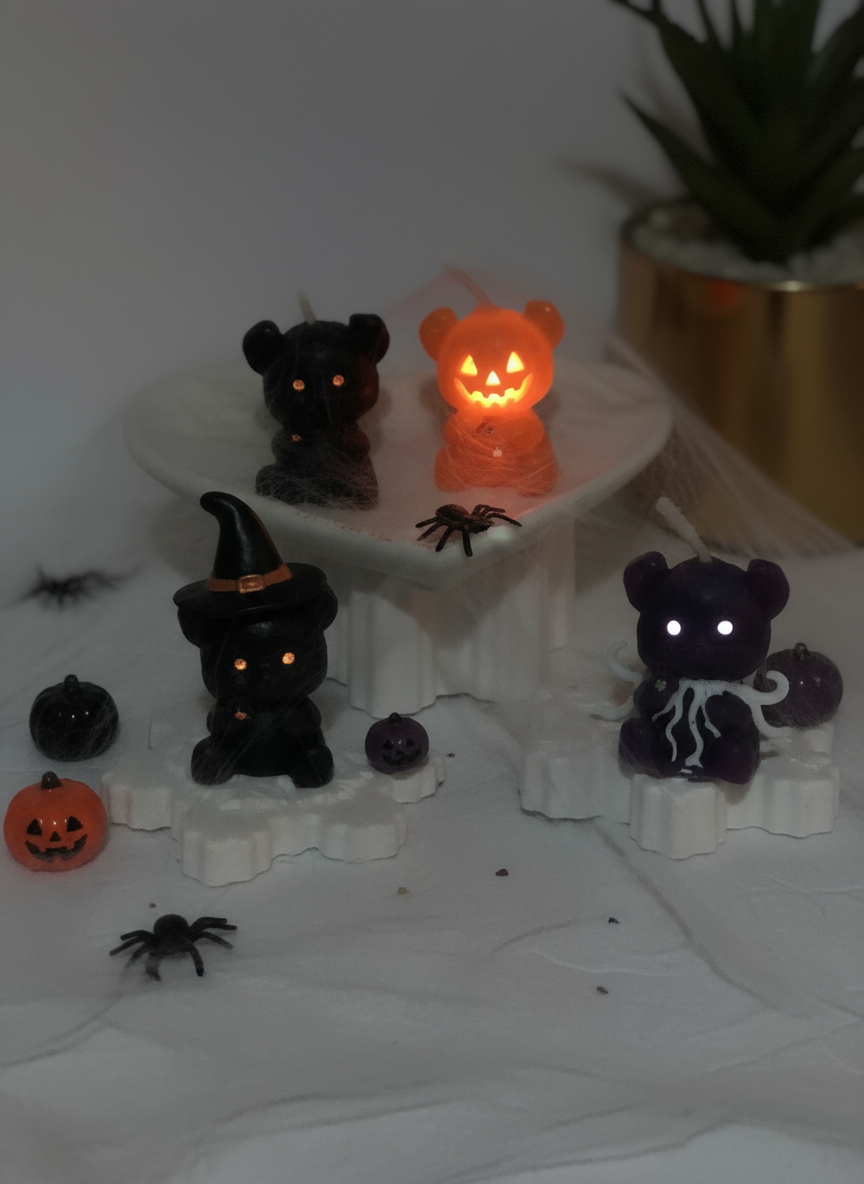 Pink bear-shaped candles on a white stand 