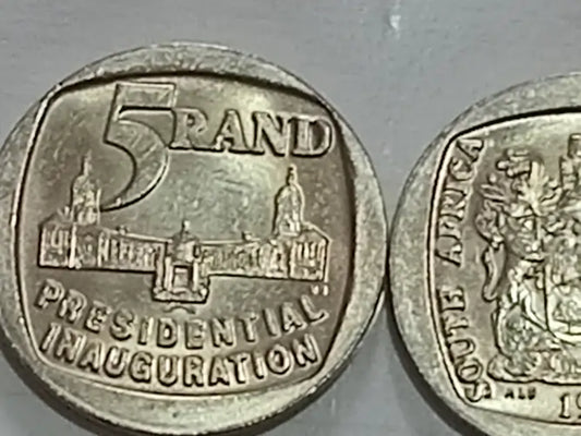 Two  1994 FIVE RAND / R5 coins, one with '5 Rand Presidential Inauguration' text and another with a coat of arms, on a gray background.