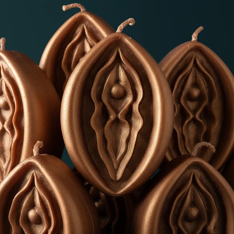 Bronze V-SPOT candles with intricate designs on a dark background