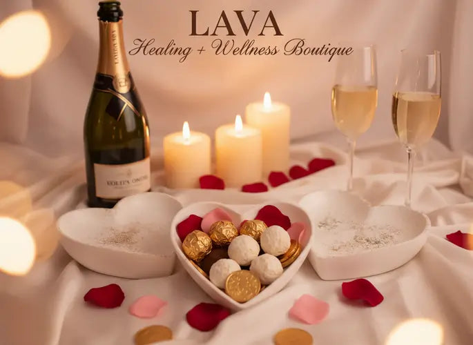 Bottle of champagne, candles, and chocolates on a table with  our 'LAVA' heart-shape-holder