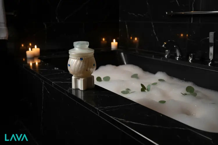 LAVA Bath tub with bubbles and candles in a dimly lit bathroom, featuring the LAVA-luxury-cubic-jar-blue-gold-s2 JAR 