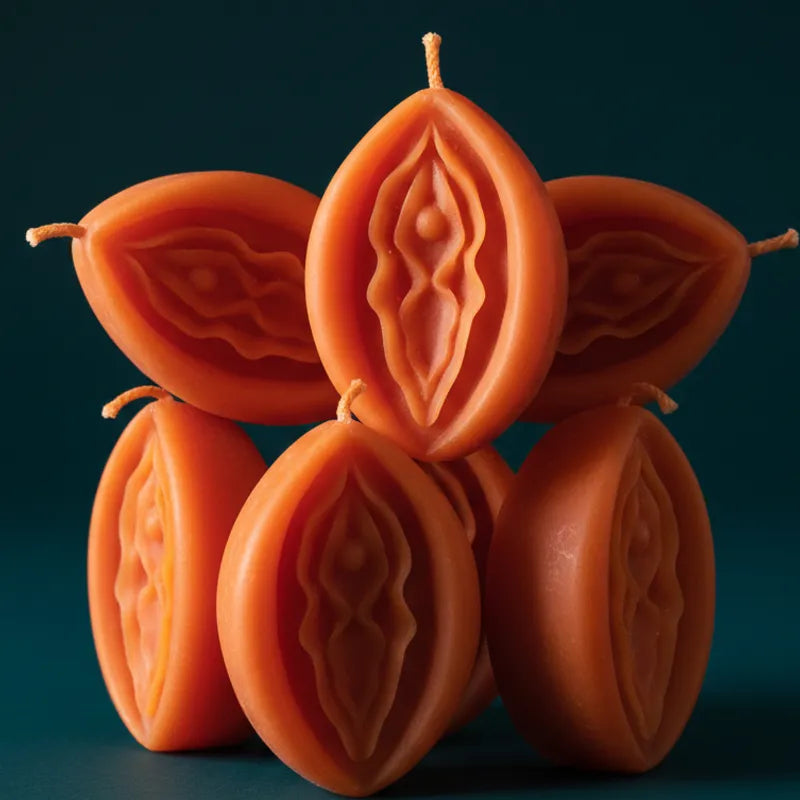 orange V-SPOT candles with intricate designs on a dark background
