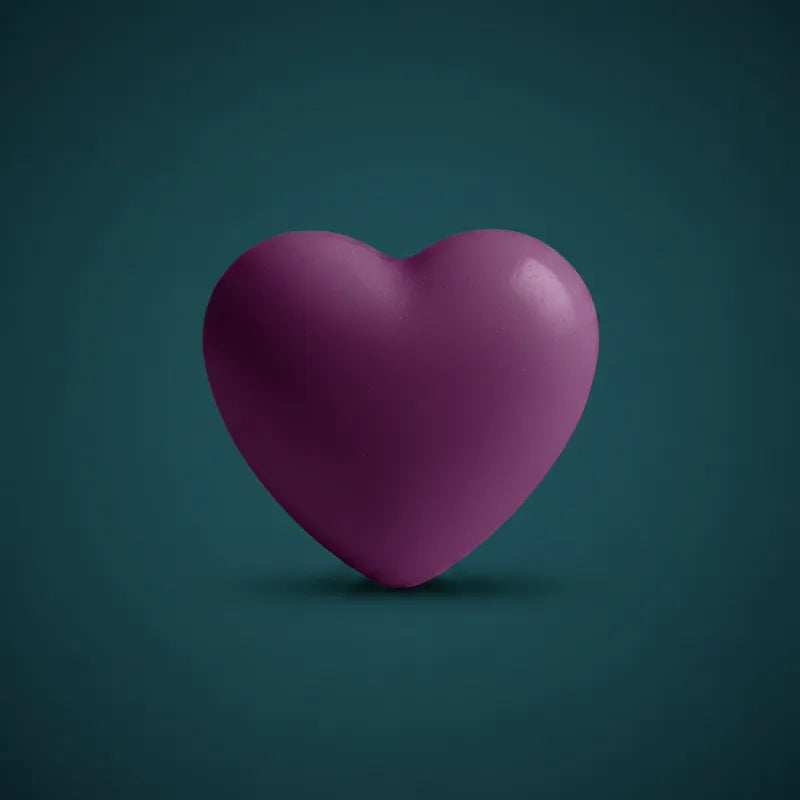 Purple heart-shaped wax candle on dark teal background – LAVA Heart Candle