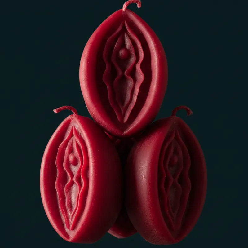RED V-SPOT candles with intricate designs on a dark background
