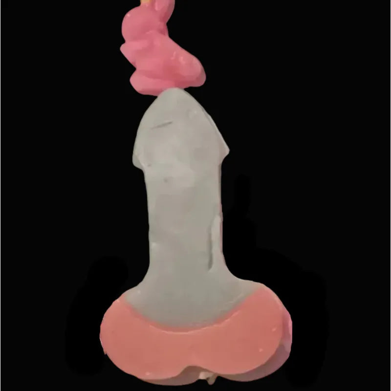 Two toned rocket mode candles in peach/pink and slate grey design on a black background. *styled with mini bunny