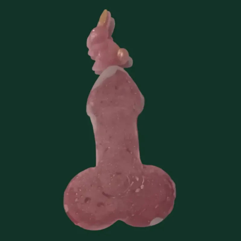 Rocket mode variant in dark pink// light purple with grey tones on top  and scattered on base, on a dark green background. mini bunny balanced at the top