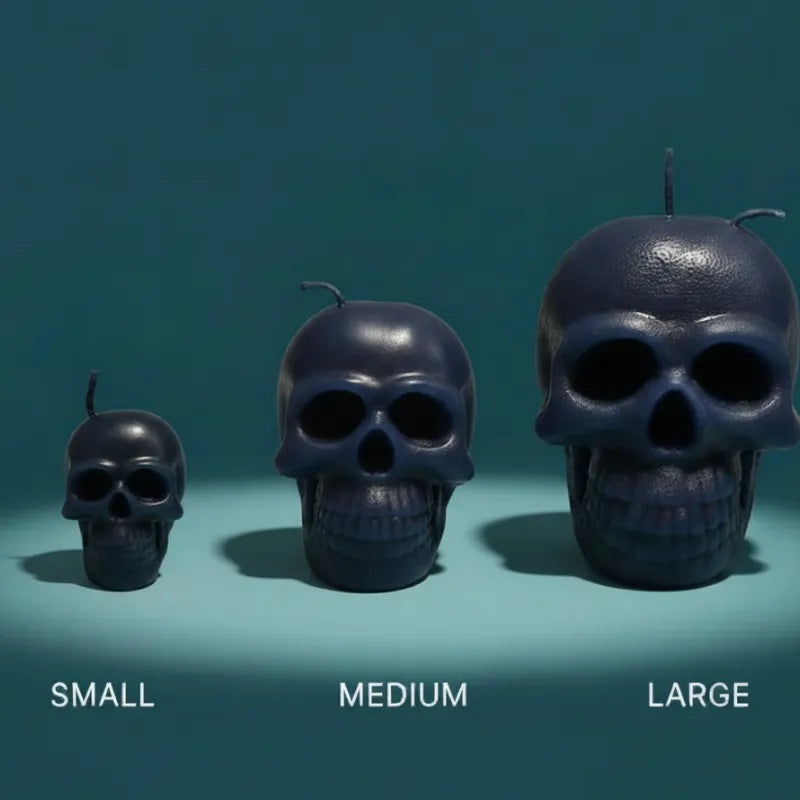 Three skull-shaped candles of different sizes on a teal background