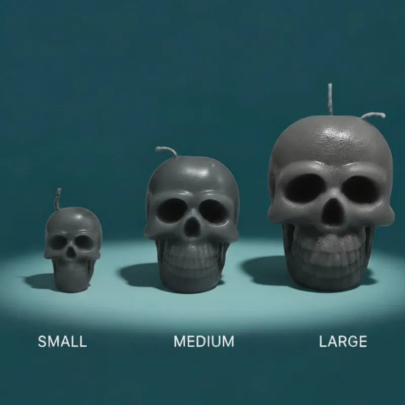 Three skull-shaped candles of different sizes on a teal background
