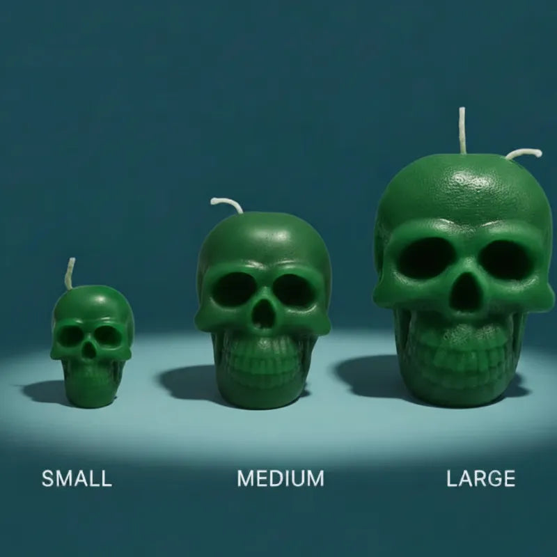 Three green skull-shaped candles of different sizes on a blue background