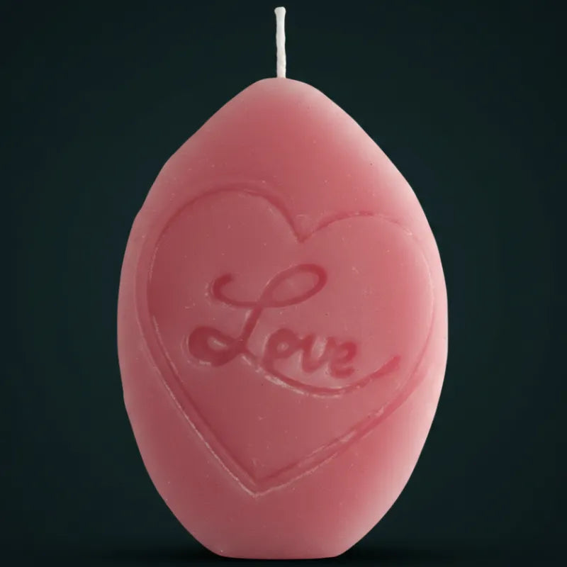 Pink reverse side of V-SPOT candle shaped like a LAVA LOGO heart with 'Love' designed on it