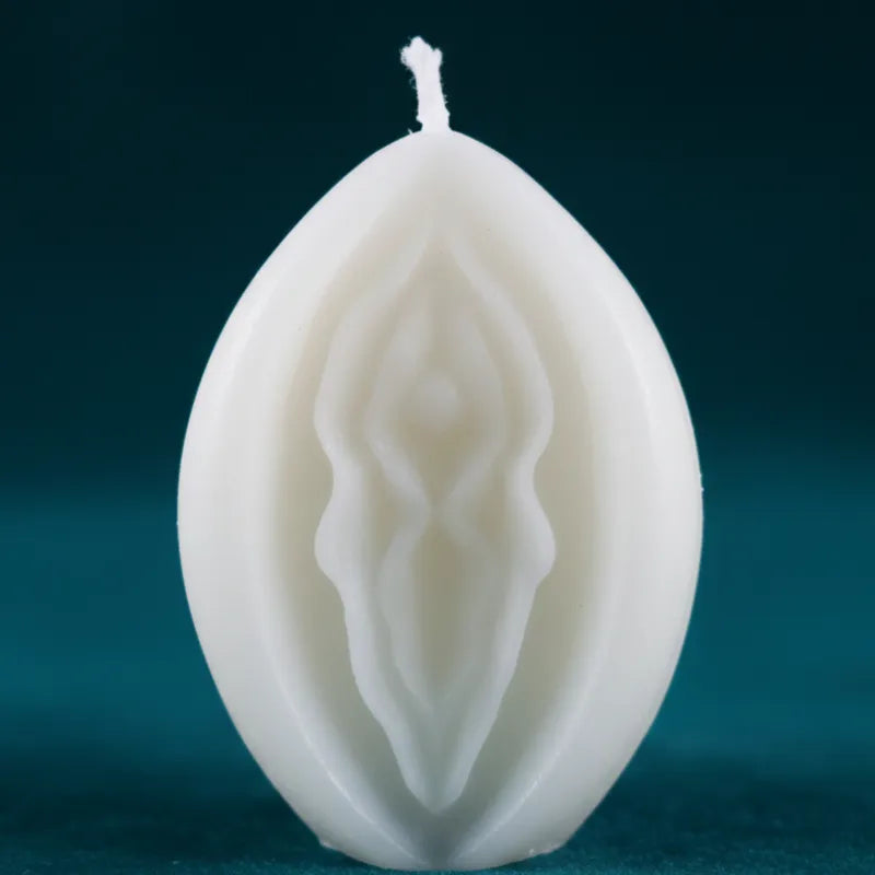WHITE V-SPOT candle with intricate designs on a dark background