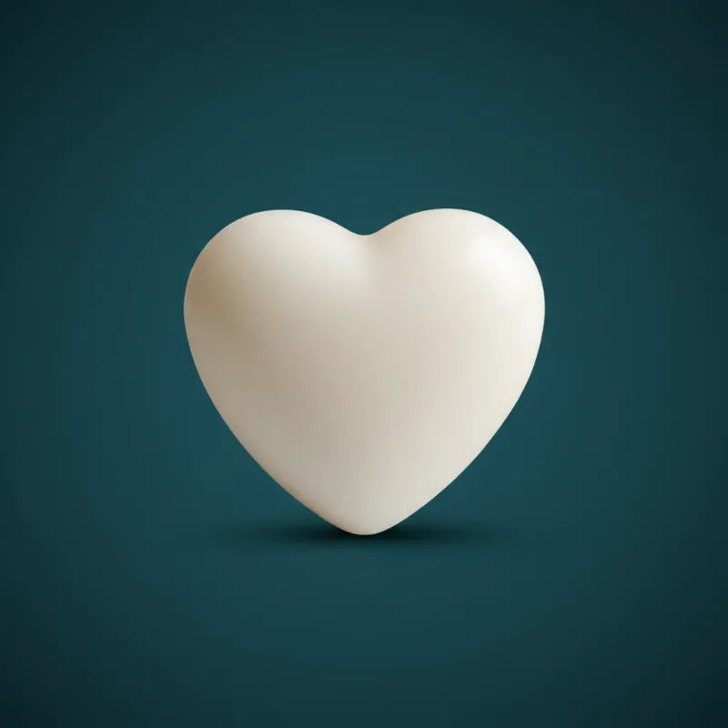 White heart-shaped wax candle on dark teal background – LAVA Heart Candle